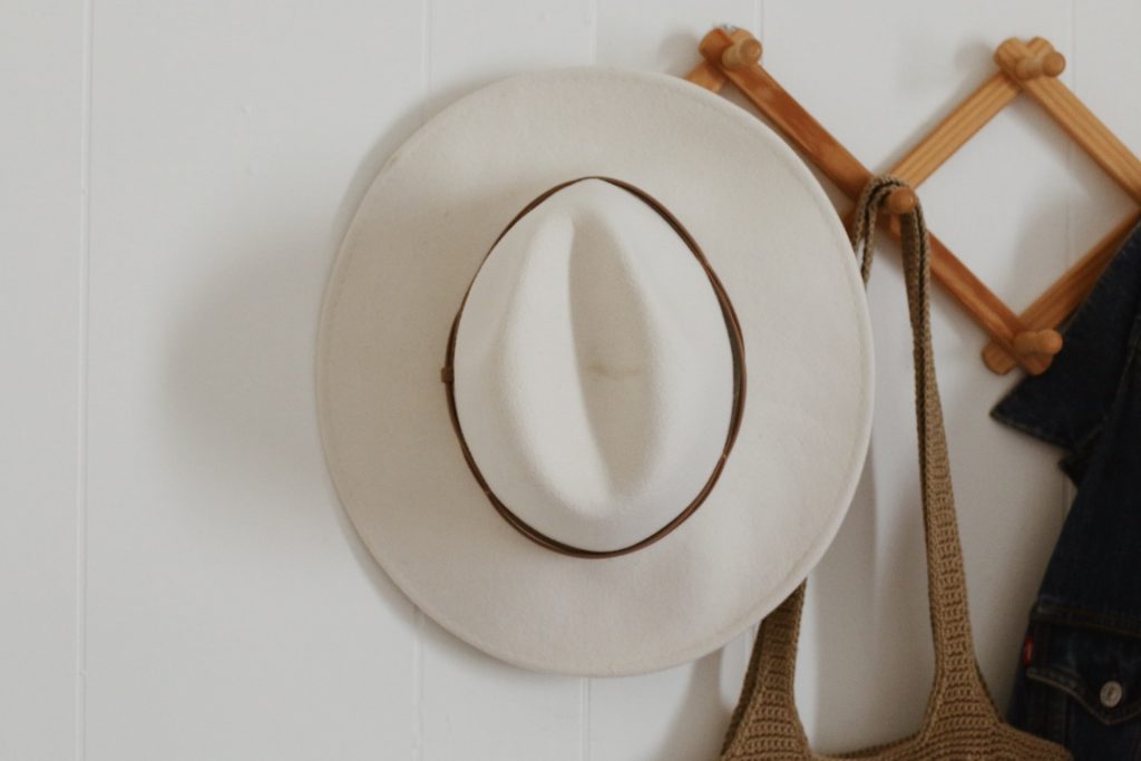 white wool rancher hat on accordion rack