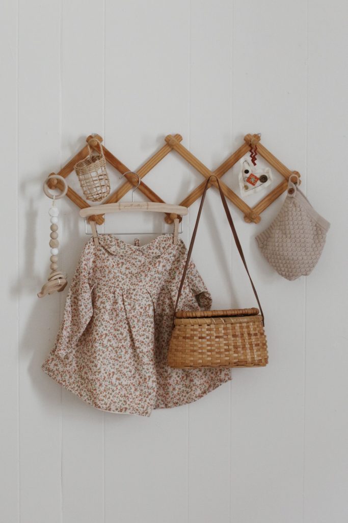 accordion wall rack with baby items hanging