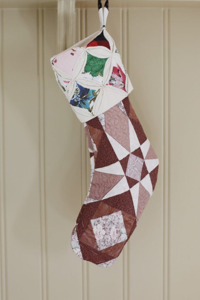 quilted stocking hanging on shelf