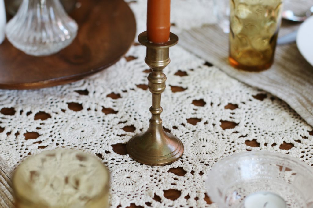 brass candlestick holding rust taper