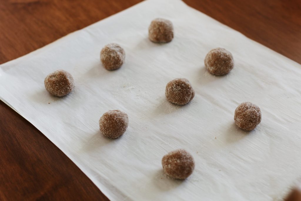 molasses cookie dough balls on parchment paper