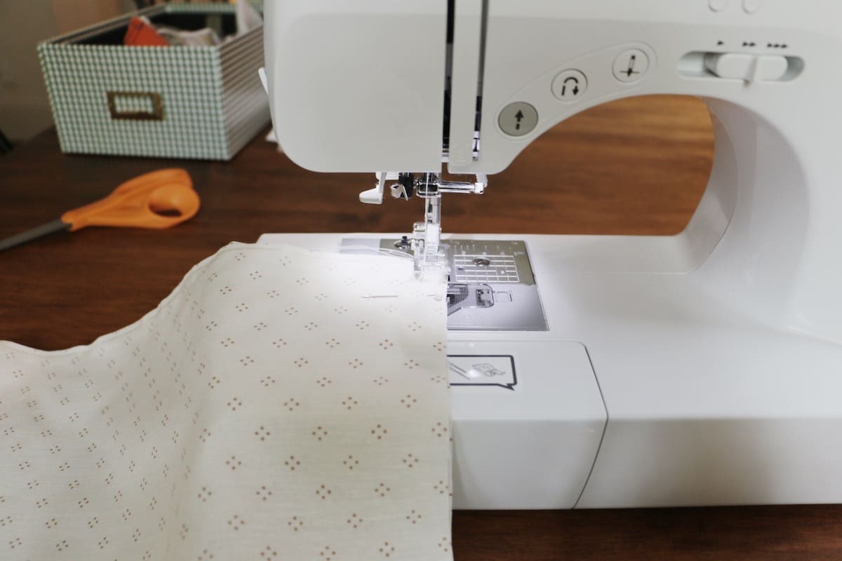 sewing machine sewing straight stitch on wood table