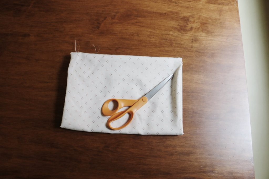 scissors on fabric on wood table